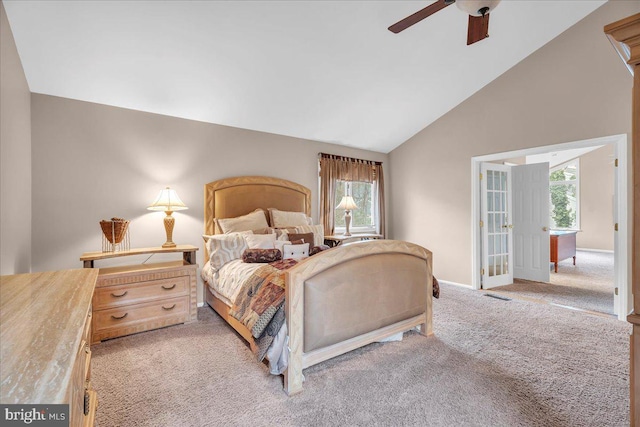 bedroom with light colored carpet, visible vents, multiple windows, and lofted ceiling