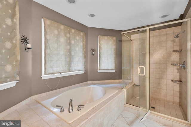 full bath featuring a stall shower, tile patterned flooring, and a bath