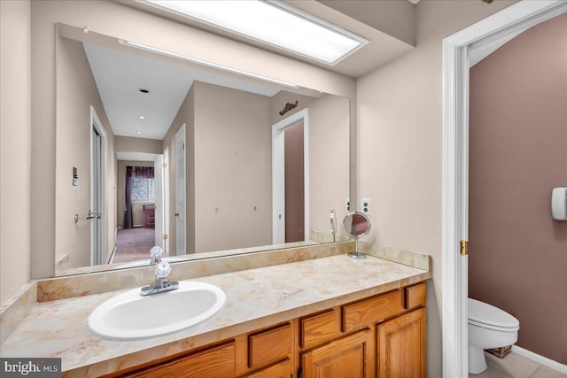 bathroom with toilet and vanity