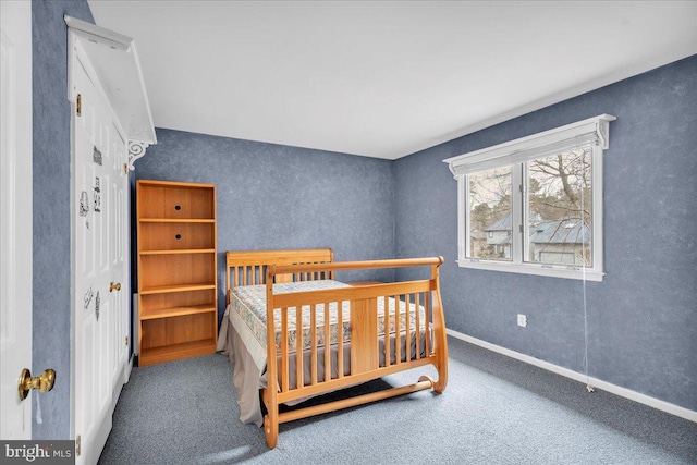 carpeted bedroom featuring baseboards