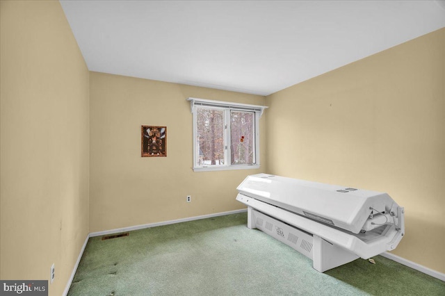 bedroom with carpet floors, visible vents, and baseboards