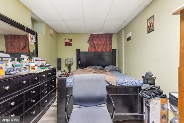 bedroom featuring a paneled ceiling and wood finished floors