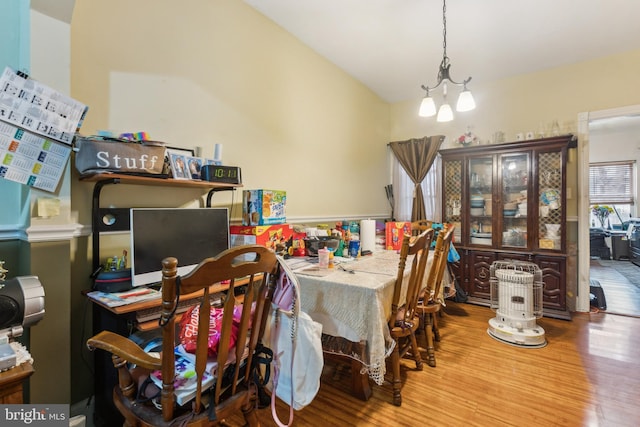 dining area with a chandelier and wood finished floors