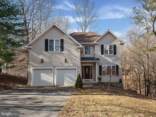 traditional-style home with aphalt driveway and an attached garage