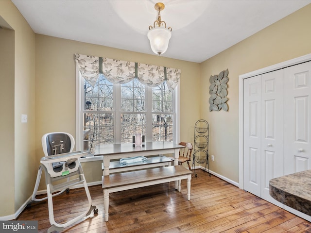 dining room featuring wood-type flooring and baseboards