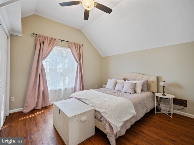 bedroom featuring ceiling fan, vaulted ceiling, baseboards, and wood finished floors