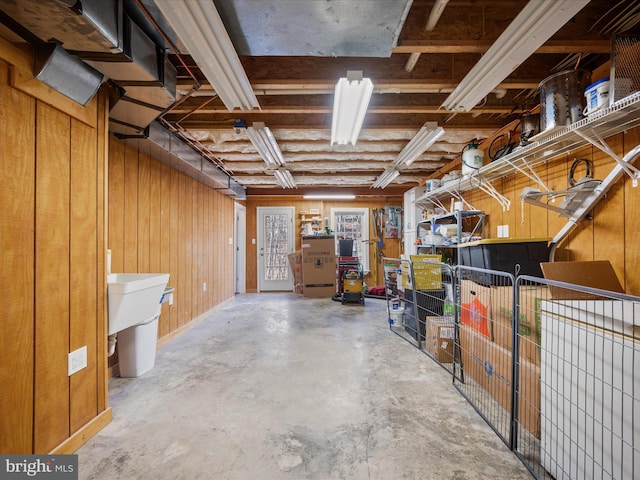 basement featuring wood walls