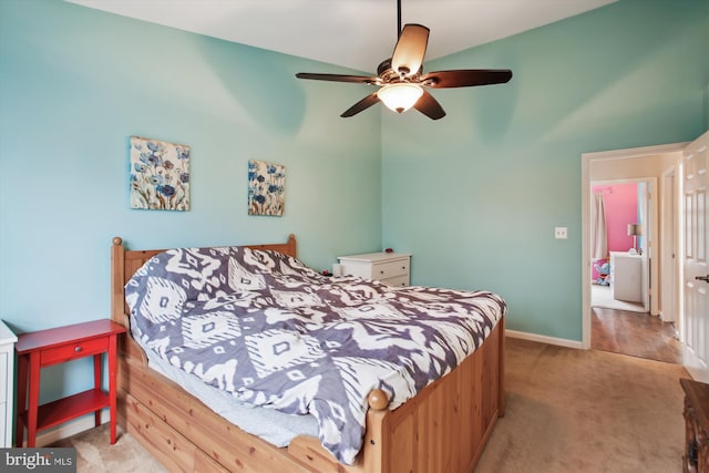 bedroom with baseboards, a ceiling fan, and light colored carpet