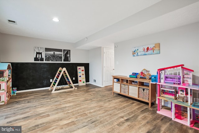 game room featuring visible vents, baseboards, and wood finished floors