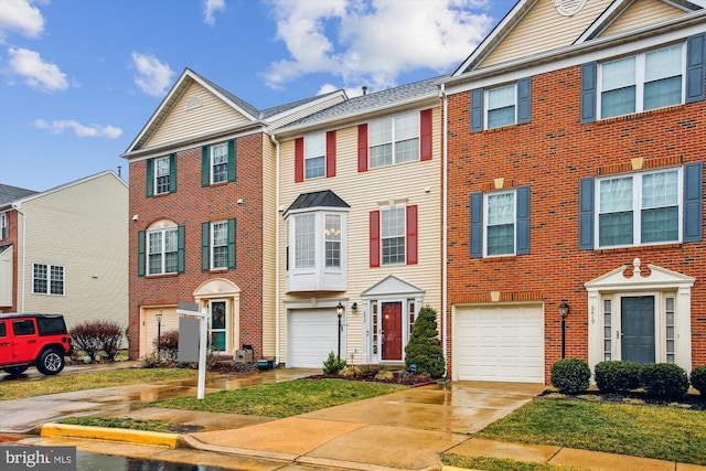 townhome / multi-family property featuring driveway and an attached garage