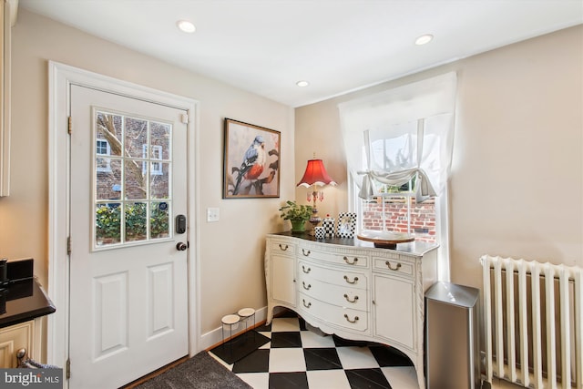 doorway featuring recessed lighting, baseboards, radiator, and dark floors