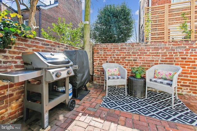 view of patio / terrace with grilling area and fence