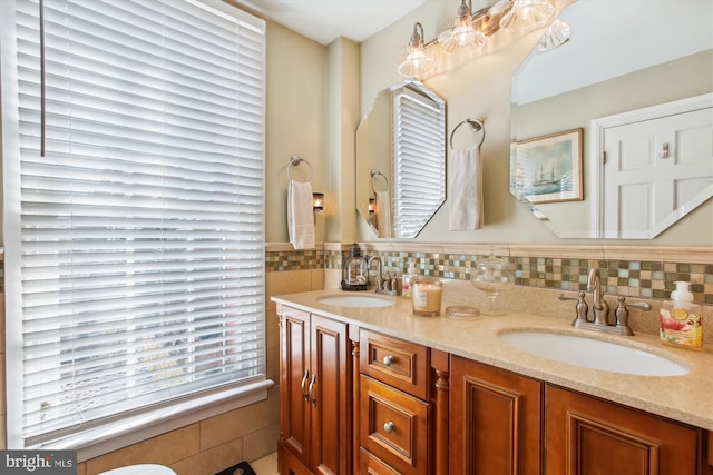 full bathroom featuring a sink and double vanity