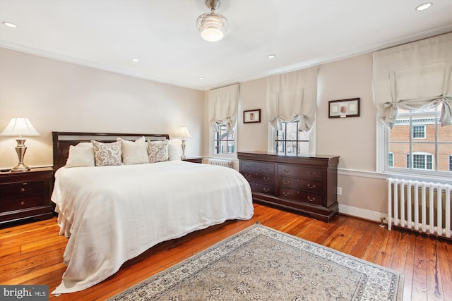 bedroom featuring crown molding, radiator, and wood-type flooring