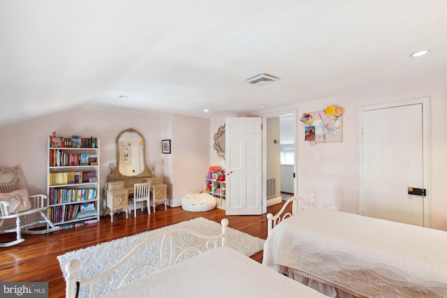 bedroom featuring visible vents, wood finished floors, recessed lighting, baseboards, and vaulted ceiling