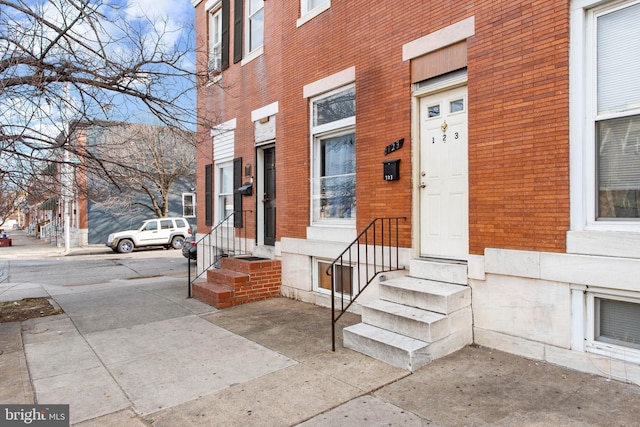 entrance to property with brick siding