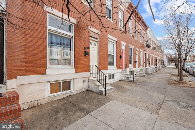 view of property featuring entry steps and a residential view