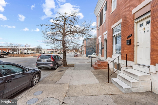 view of road with entry steps and sidewalks