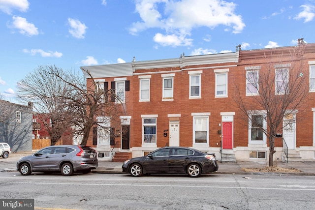 view of front facade with entry steps and brick siding