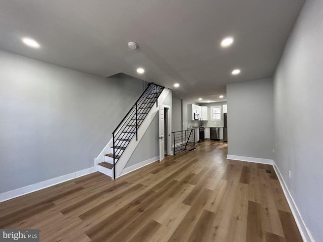 interior space featuring recessed lighting, stairway, baseboards, and dark wood finished floors