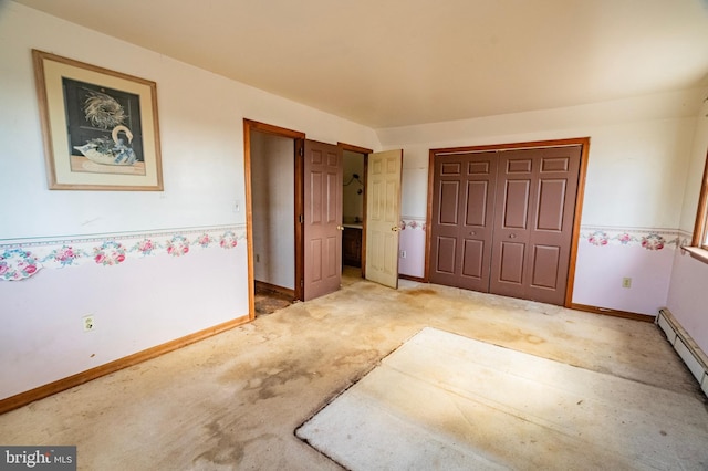 interior space featuring a baseboard heating unit, a closet, carpet flooring, and baseboards