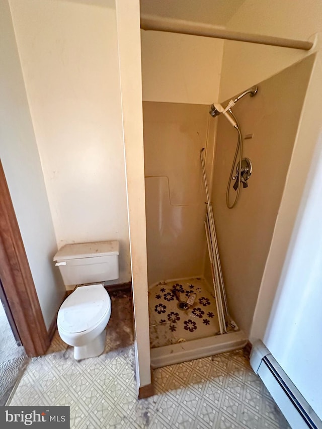 full bath featuring a baseboard heating unit, a shower stall, and toilet