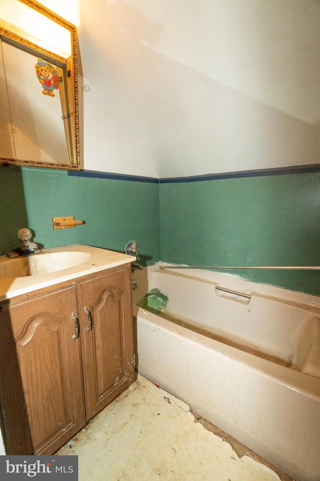 bathroom with a garden tub and vanity