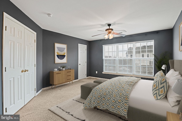 bedroom featuring baseboards, ceiling fan, and light colored carpet