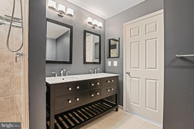 bathroom with double vanity, tile patterned flooring, and a sink