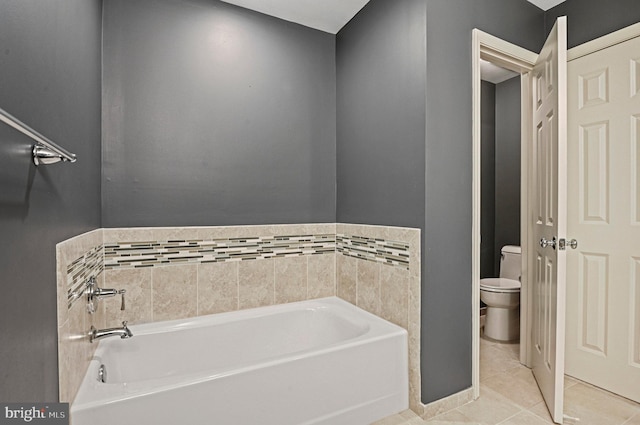 bathroom featuring a bath, toilet, and tile patterned floors