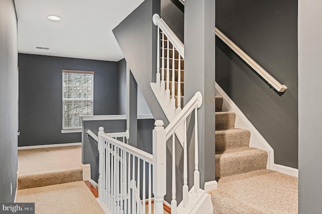 stairs featuring carpet floors, visible vents, and baseboards