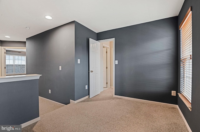 interior space featuring carpet and baseboards