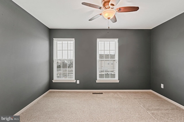 unfurnished room with ceiling fan, carpet, and baseboards