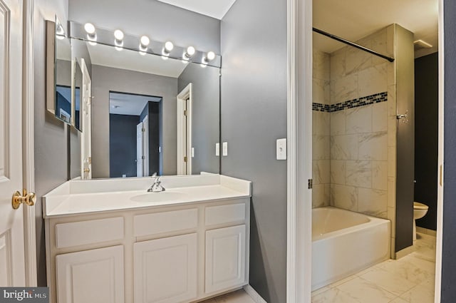 bathroom featuring baseboards, toilet, marble finish floor, vanity, and washtub / shower combination