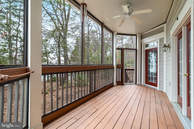 unfurnished sunroom with a ceiling fan