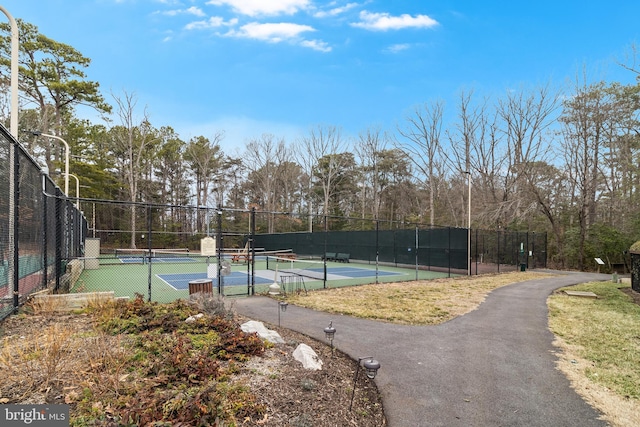 view of sport court featuring fence