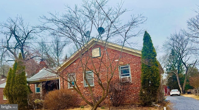 view of property exterior with brick siding