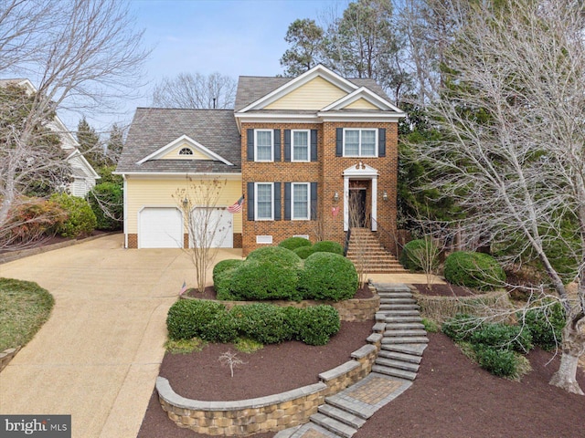 view of front facade with concrete driveway, brick siding, and roof with shingles