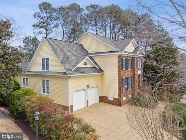 view of property exterior featuring a garage, crawl space, driveway, and brick siding