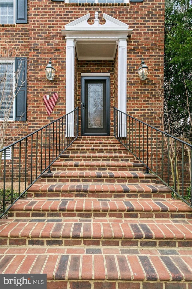 view of exterior entry with brick siding