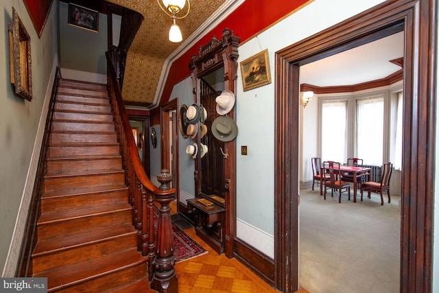 stairs with baseboards and ornamental molding