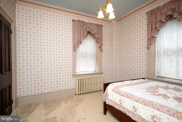 carpeted bedroom featuring a notable chandelier, baseboards, ornamental molding, radiator heating unit, and wallpapered walls