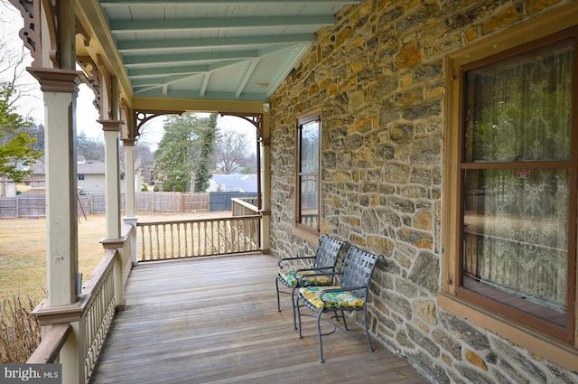 wooden deck with covered porch and fence