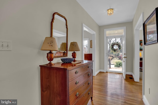 foyer featuring light wood-style floors and baseboards