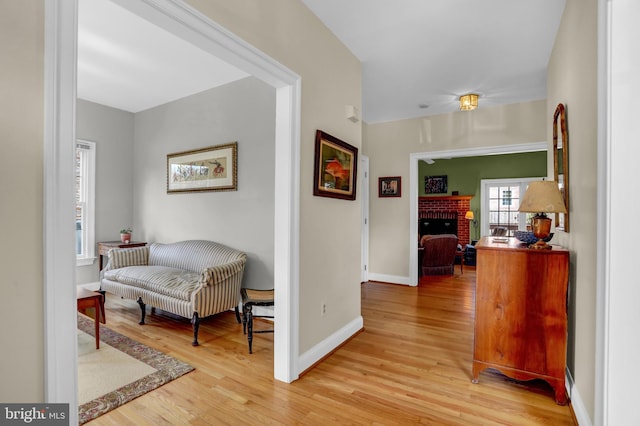 hallway with light wood-style flooring and baseboards