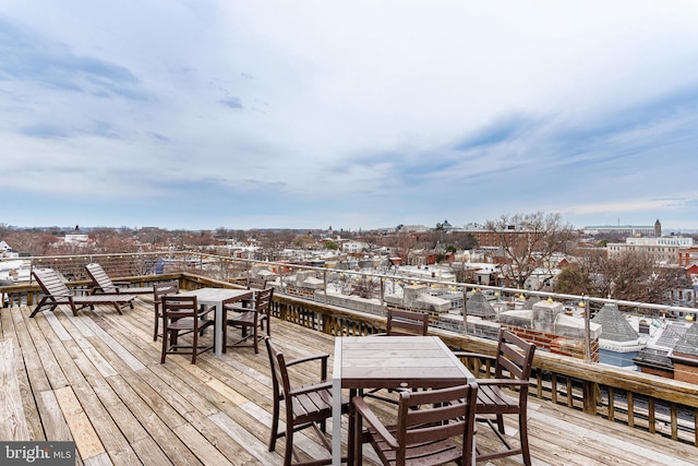 wooden terrace featuring outdoor dining area