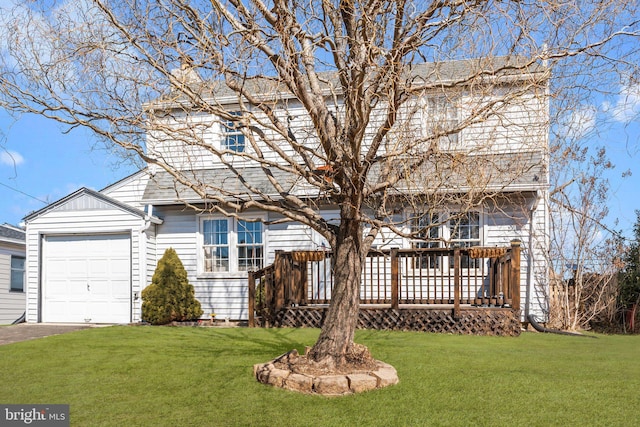 traditional-style house with a garage, aphalt driveway, a front lawn, and a wooden deck