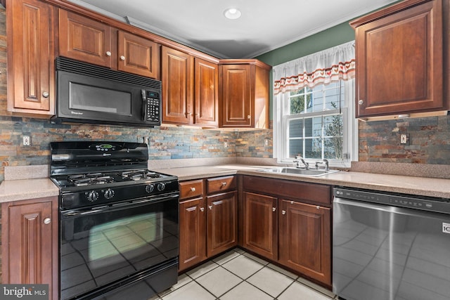 kitchen with light tile patterned floors, a sink, light countertops, black appliances, and backsplash