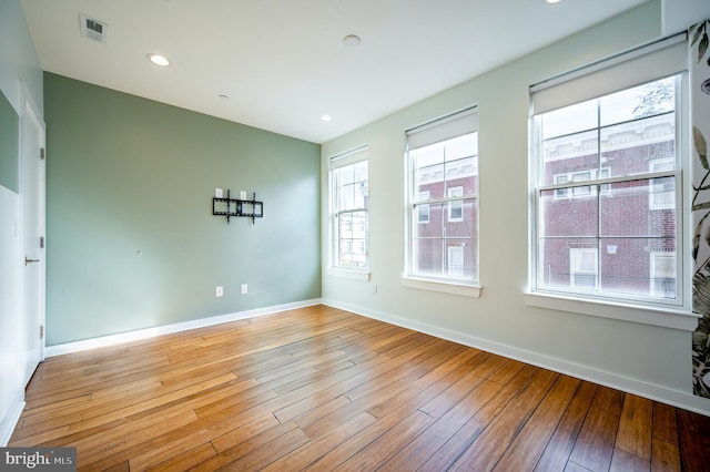 unfurnished room featuring recessed lighting, baseboards, visible vents, and light wood finished floors