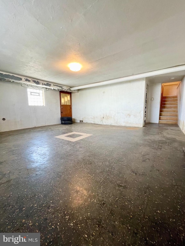 unfurnished living room with stairway and a textured ceiling